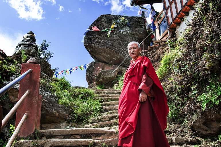 770 Bhutan Buddhist monk on the stairway way to Tiger nest monastery shutterstock 712443097