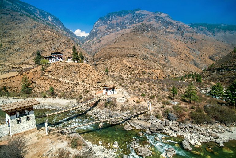 770 Bhutan Tamchog Lhakhang and Traditional Suspension Bridge shutterstock 707090872