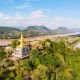 1280 golden pagoda of Wat Chom Si on the top of Mount Phou Si shutterstock 1402519127